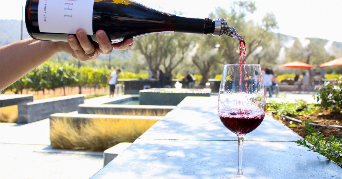 Pouring red wine at MOHI Ranch vineyard in Morgan Hill CA during an outdoor tasting experience