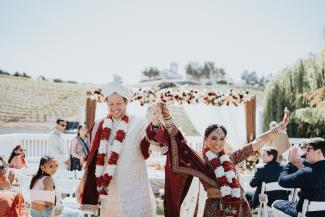 Newly married couple celebrating their vineyard wedding with all inclusive wedding services at Léal Vineyards.