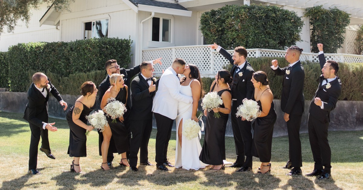 Wedding party celebrating the couple outdoors at a Morgan Hill wedding venue with vineyard scenery