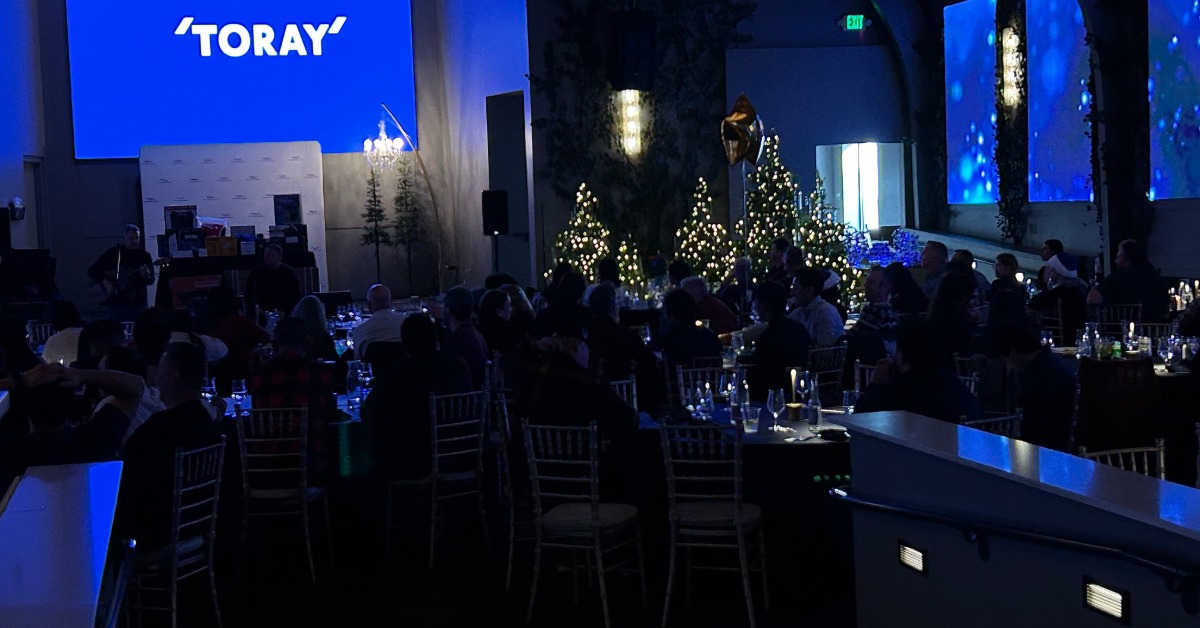 Elegant corporate event venue in California with stage lighting and seated guests during an evening program