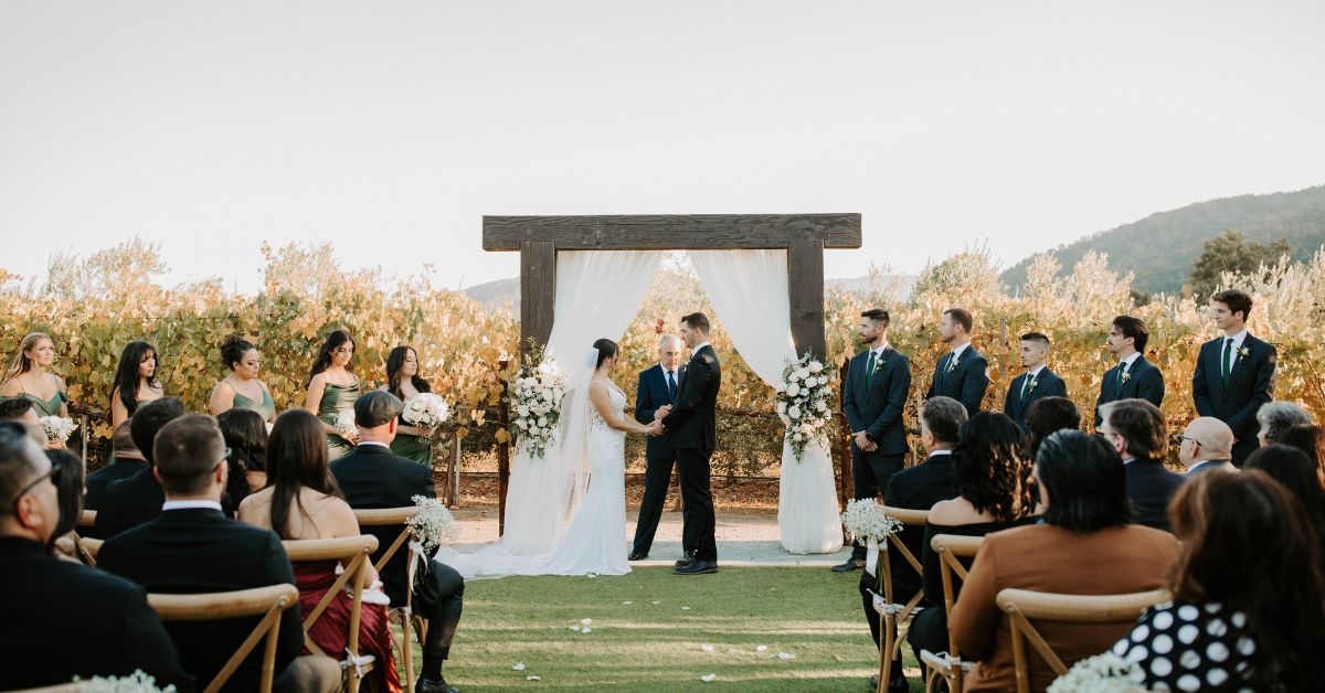 Outdoor vows with bridal party highlighting Léal Vineyards vineyard wedding packages