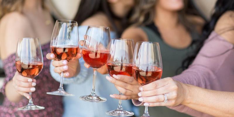 Friends enjoying rosé at a winery in Hollister CA during a relaxed tasting experience