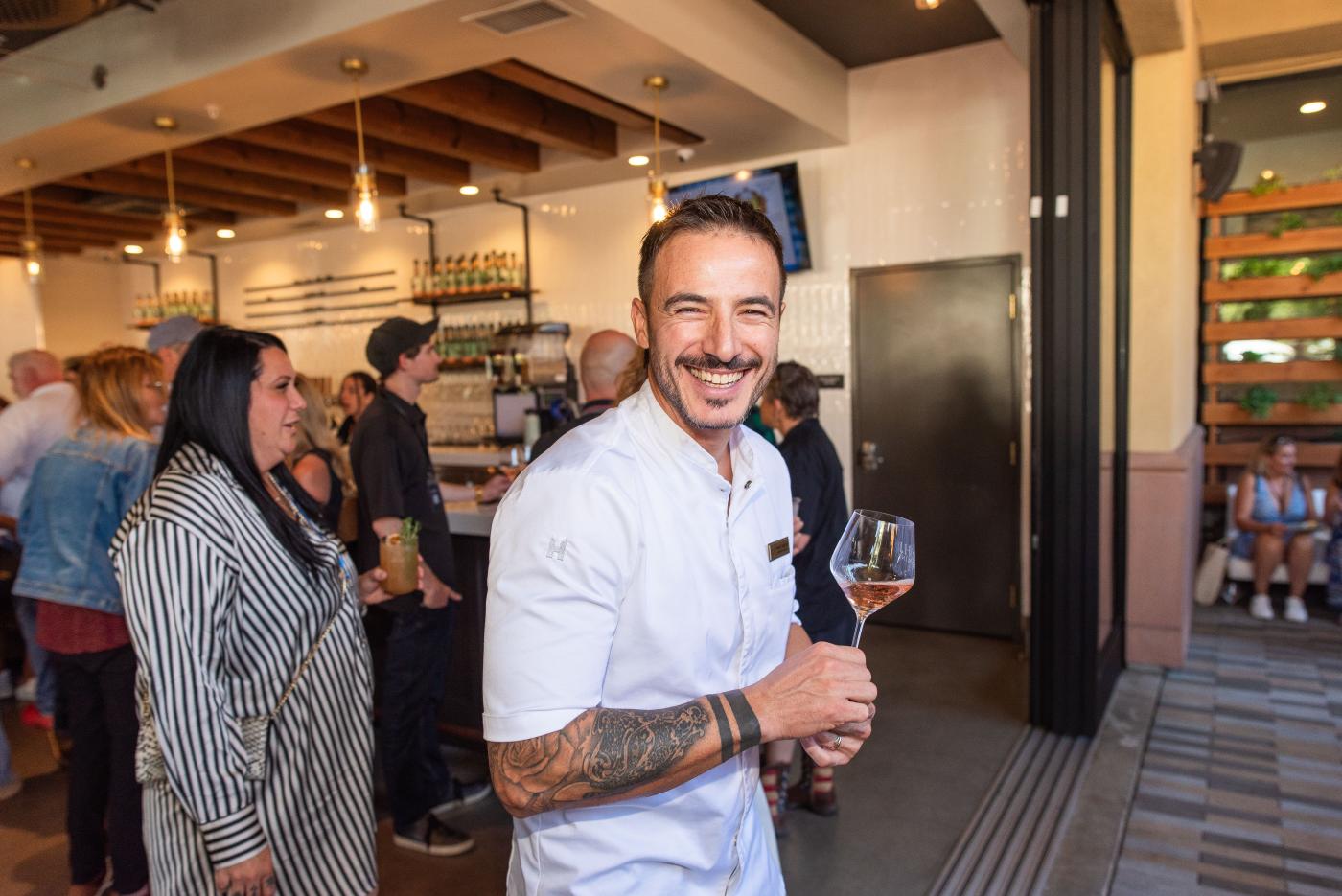 Holding a glass at MOHI Food and Wine festival