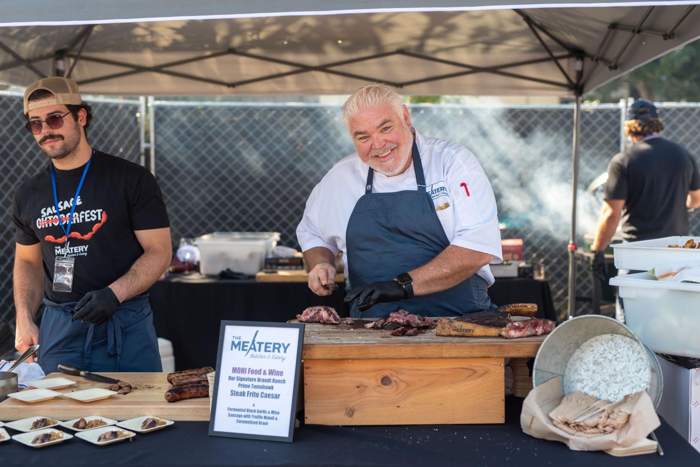 Chef Todd Fisher holding meat at MOHI Food and Wine festival