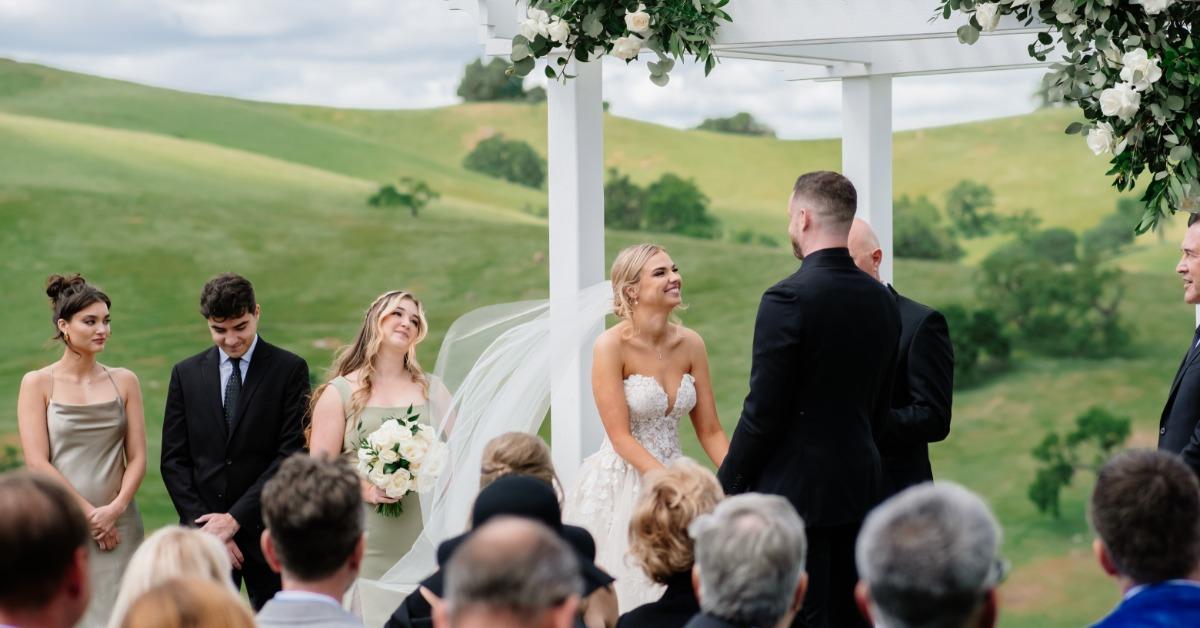 California vineyard wedding ceremony with scenic hills and outdoor arbor setting