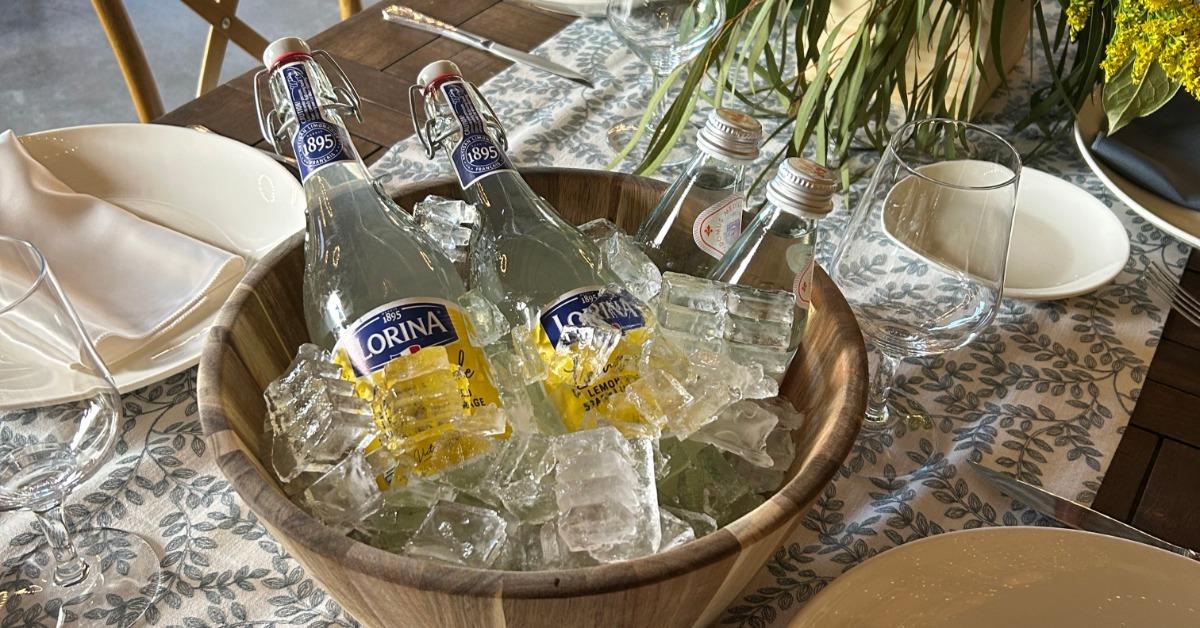 Elegant gala table setup at a California wine country private event venue with floral centerpiece and chilled sparkling beverages