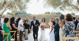Bride walking down the aisle with her father at Léal Vineyards, one of the most enchanting wedding venues in Morgan Hill